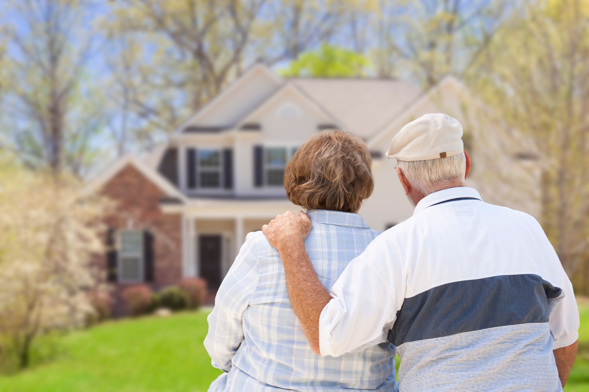 Older couple looking toward their home together